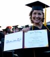 Becky Drace, graduating social work major, celebrates by showing off her diploma at the spring 2010 commencement ceremony. 
 - Photo by Ebbie Davis