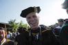 Dr. Steven Carls, University Professor of History and Department Chair, laughs as he stands for the processional at the spring 2010 commencement ceremony.  - Photo by Morris Abernathy