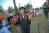 Chanel Watson, graduating business administration major, holds up her shoes after receiving her diploma. Watson unintentionally provided some entertainment for the spring 2010 commencement ceremony when she lost her shoes on stage.  - Photo by Morris Abernathy