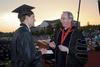 Dr. David S. Dockery, president of Union University, presents graduating broadcast journalism major, Matthew Kuchem, with the Tigrett Medal at the spring 2010 commencement ceremony.  - Photo by Morris Abernathy