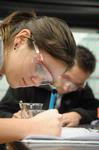 Students take notes after a chemistry experiment in lab. - Photo by Morris Abernathy
