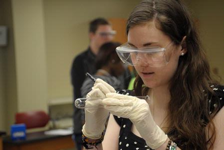 Students work on an experiment in biology lab.