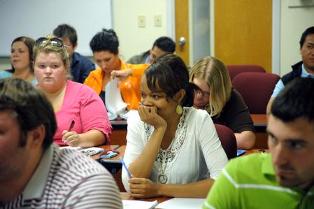 Students listen and take notes in Dr. Bryan Dawson's math class. 