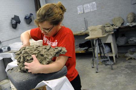 Kelsey Roberts, senior art major, works on a sculpture in the art department. 
