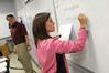 Dr. Troy Riggs, professor of mathematics, watches as his students write their homework problems on the board before class. - Photo by Morris Abernathy