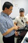 Dr. Don Van, professor of engineering and department chair, helps a student in lab. - Photo by Morris Abernathy
