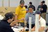Dr. Don Van, professor of engineering and department chair, helps a group of students with a lab assignment. - Photo by Morris Abernathy