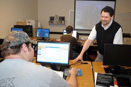 Dr. Jan Wilms, professor of computer science and department chair, helps a student with an assignment.
