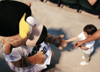Ribbee takes some time to meet and greet even the smallest fan.  Ribbee makes certain to shake the hand of one eager young fan before heading off to entertain the crowd. - Photo by Justin Veneman