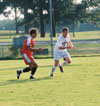 Kyle McDiarmid (8) an opponent in pursuit of the ball. - Photo by Uncredited