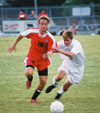 Christopher Printice (18) races for the ball as a defender is with him stride for stride. - Photo by Uncredited