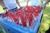 Over 1000 bottles of ice water were handed out to graduates and family at this year's summer graduation, held on the Great Lawn. - Photo by Morris Abernathy