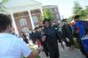 Graduates reach for cold bottles of water to beat the heat at summer graduation.  - Photo by Morris Abernathy
