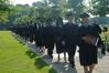 Graduates make their way to their seats for summer graduation on the Great Lawn. - Photo by Morris Abernathy