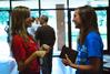 Emily Logan, senior music major, talks with incoming freshman Savannah Hari during check-in on New Student Move In Day.  - Photo by Abigail Harris