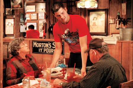 Senior Paul Monroe, marketing major, serves a couple dining at The Old Country Store. He is also the SIFE project manager for the newest marketing endeavor to help localize the restaurant to local patrons and tourists alike.