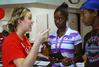 Amy Brown, enrollment counselor, talks to Aneice Lunsford, incoming freshman, and her brother Andrie about the schedule for Move In Day.  - Photo by Abigail Harris