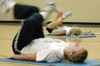 Freshman Sabrina White, history major, does some abdominal work during the early morning hours on Friday. She keeps an eye on her aerobics instructor, sophomore Emily Kuhnert, athletic training major. - Photo by Lindsay Stavish