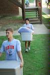 Soccer players Taylor Mayo and Jose Marroquin help new students move their things into the dorms on Move In Day.  - Photo by Abigail Harris
