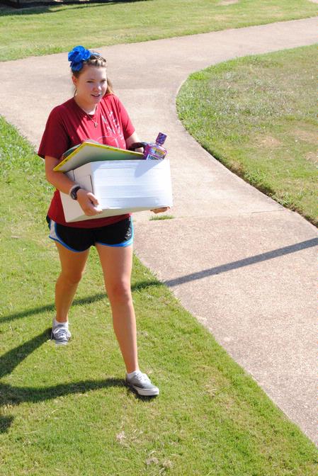 Anika Strand, sophomore, helps out during new student Move In Day.