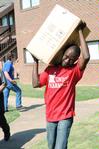 Richard Addo, associate professor of pharmacy, helps freshman students move in for the 2010 Fall semester. - Photo by Victoria Stargel
