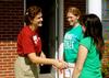 Danae Pacileo, resident advisor, greets new student, Sarah Love from North Carolina, who is living in her building. - Photo by Ebbie Davis