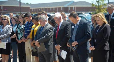 Faculty, staff, and friends of Union bow in prayer during the dedication service for the Hope Residence Complex. 