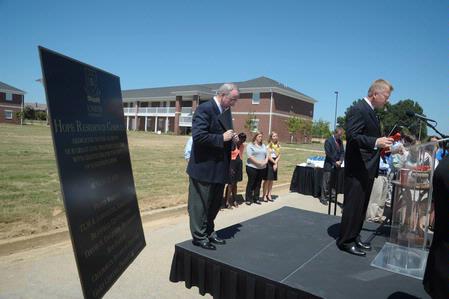 Rod Parker, chairman of the board of trustees, leads in the benediction after the dedication of the Hope Residence Complex. 