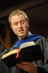 Christopher Mathews associate professor of music and department chair, leads the congregation at Fall Convocation in the hymn Immortal, Invisible, God Only Wise. - Photo by Morris Abernathy