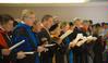 Faculty members, dressed in their academic regalia, sing during the Fall Convocation address.  - Photo by Morris Abernathy