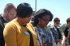 Zachery Pendergrass, Jacqueline Taylor, and Renee Jones bow in prayer during the dedication of the Hope Residence Complex.  - Photo by Beth Spain