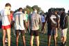 Coach Gary Johnson leads the Union Cross Country team in prayer after a morning practice. - Photo by Ebbie Davis