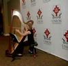 Anna Wicker, senior music major, plays the harp for entertainment at the President's Reception. - Photo by Deanna Santangelo