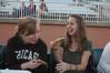 Sophomores Taylor Glover, nursing major, and Miranda Jackson, elementary education major, laugh together during the West Tenn Diamond Jaxx Union Night at Pringles Park.  - Photo by Beth Spain