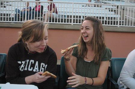 Sophomores Taylor Glover, nursing major, and Miranda Jackson, elementary education major, laugh together during the West Tenn Diamond Jaxx Union Night at Pringles Park. 
