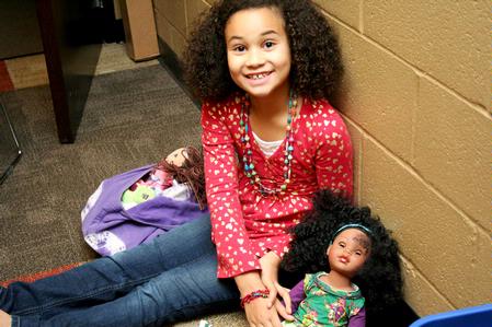 Hailey Jackson, daughter of Paul Jackson, professor of Biblical studies, smiles as she plays with her doll during the Go Week: Reaching the Nations through Adoption event. 
