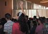 Students raise their hands in praise while singing in chapel. - Photo by Victoria Stargel