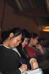 Kendra Loh, freshman psychology major, takes notes during GO week chapel.  - Photo by Victoria Stargel
