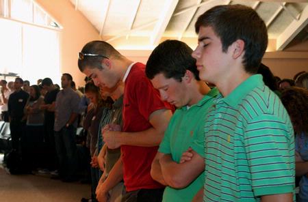 Joey Davis, freshman, gathers with other Union students for prayer during GO Week chapel.