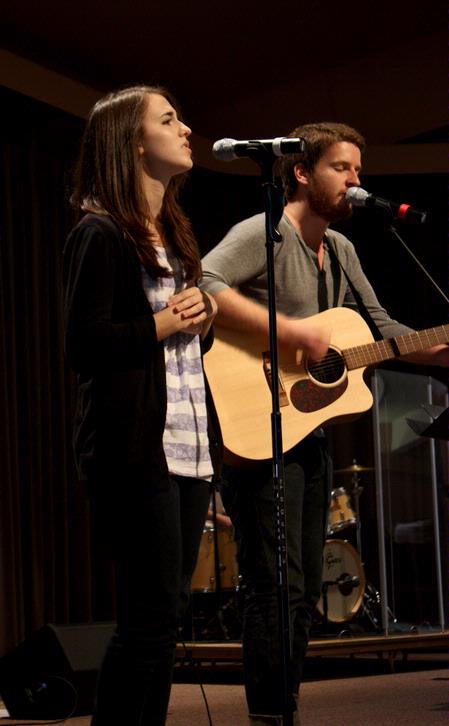 Natalie Wittman, junior English major, and TJ Hester, junior philosophy major, lead students in music at a Global Outreach chapel.