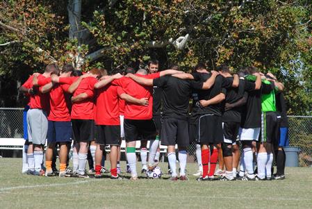 Union soccer alumni huddle with the bulldog jv soccer team before playing a game against each other. 