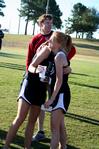Carissa Wilson, senior elementary education major, hugs her teammate after a cross country meet.  - Photo by Deanna Santangelo