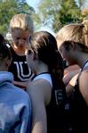 The women's cross country team gathers for a prayer after competing in a meet held on campus.  - Photo by Deanna Santangelo