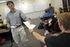 Kevin Chen, assistant professor of Biblical studies, hands out papers to his class.  - Photo by Morris Abernathy