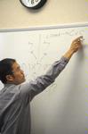 Kevin Chen, assistant professor of Biblical studies, demonstrates some Hebrew writing in class.  - Photo by Morris Abernathy