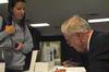 Dr. Daniel Walker Howe, Pulitzer Prize-winning author, signs a copy of his book, <em>What Hath God Wrought</em>, for Brandi Rankin, senior elementary education major. - Photo by Victoria Stargel