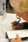 Dr. Daniel Walker Howe, Pulitzer Prize-winning author, signs a copy of his book, <em>What Hath God Wrought</em>, after lecturing for the Carls-Schwerdfeger History Lecture Series. - Photo by Victoria Stargel