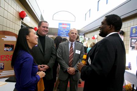 Nigel Manuel (right), senior media communications major, talks with Rachel Vo Marshall, staff assistant to the Hundley Center for Academic Enrichment, Keith Absher, dean of the McAfee School of Business Administration, and Bill Nance, associate professor of management, at Career U. 