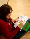 Lesley Guilaran, special programs academic liaison, fills out an activity for her Operation Christmas Child box during Campus and Community Day. - Photo by Deanna Santangelo