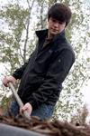 Team leader, Nic Seaborn, senior Christian studies major, shovels and lays mulch at Liberty Garden Park during Campus and Community Day.  - Photo by Ebbie Davis
